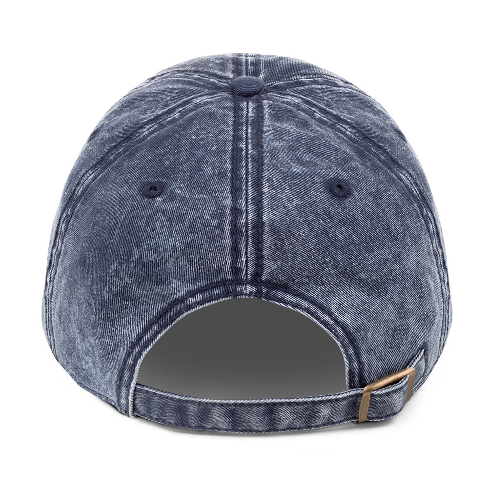 Blue denim cap with a strap on a white background