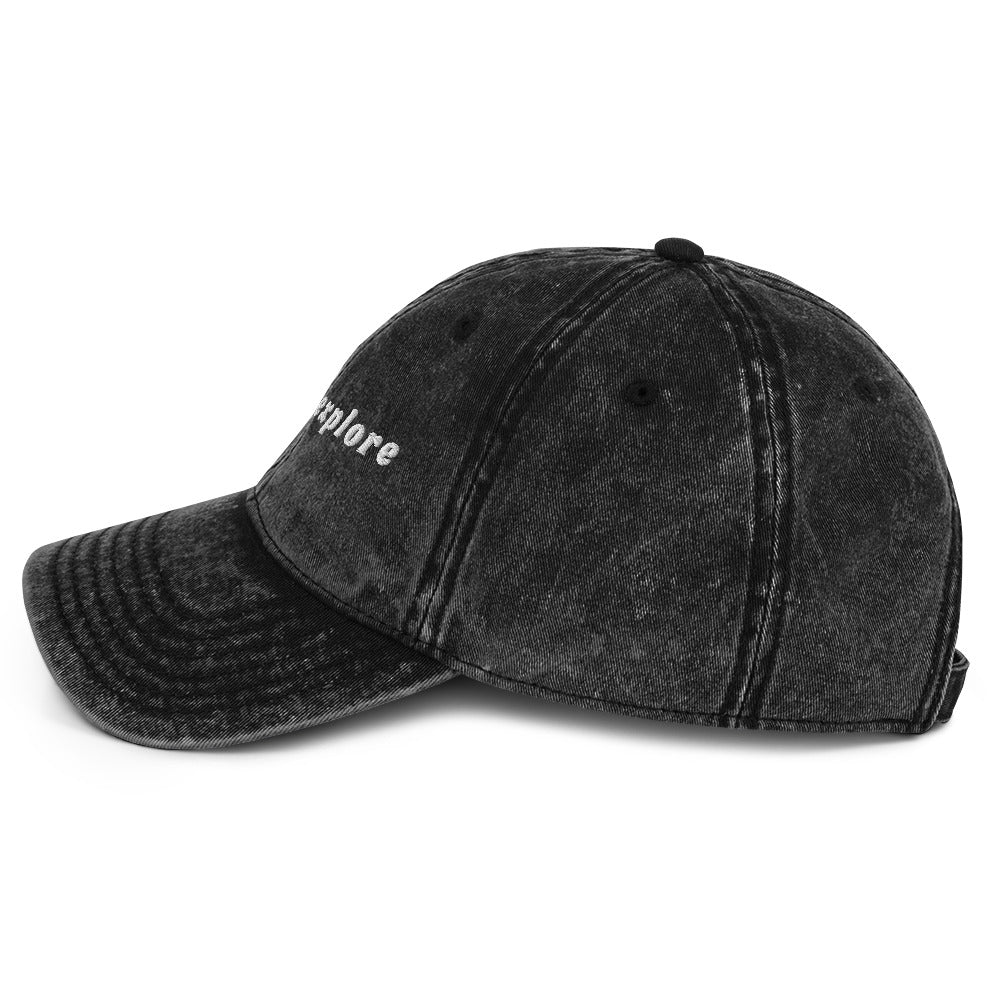 Black distressed baseball cap with 'born to Explore' embroidery on a white background