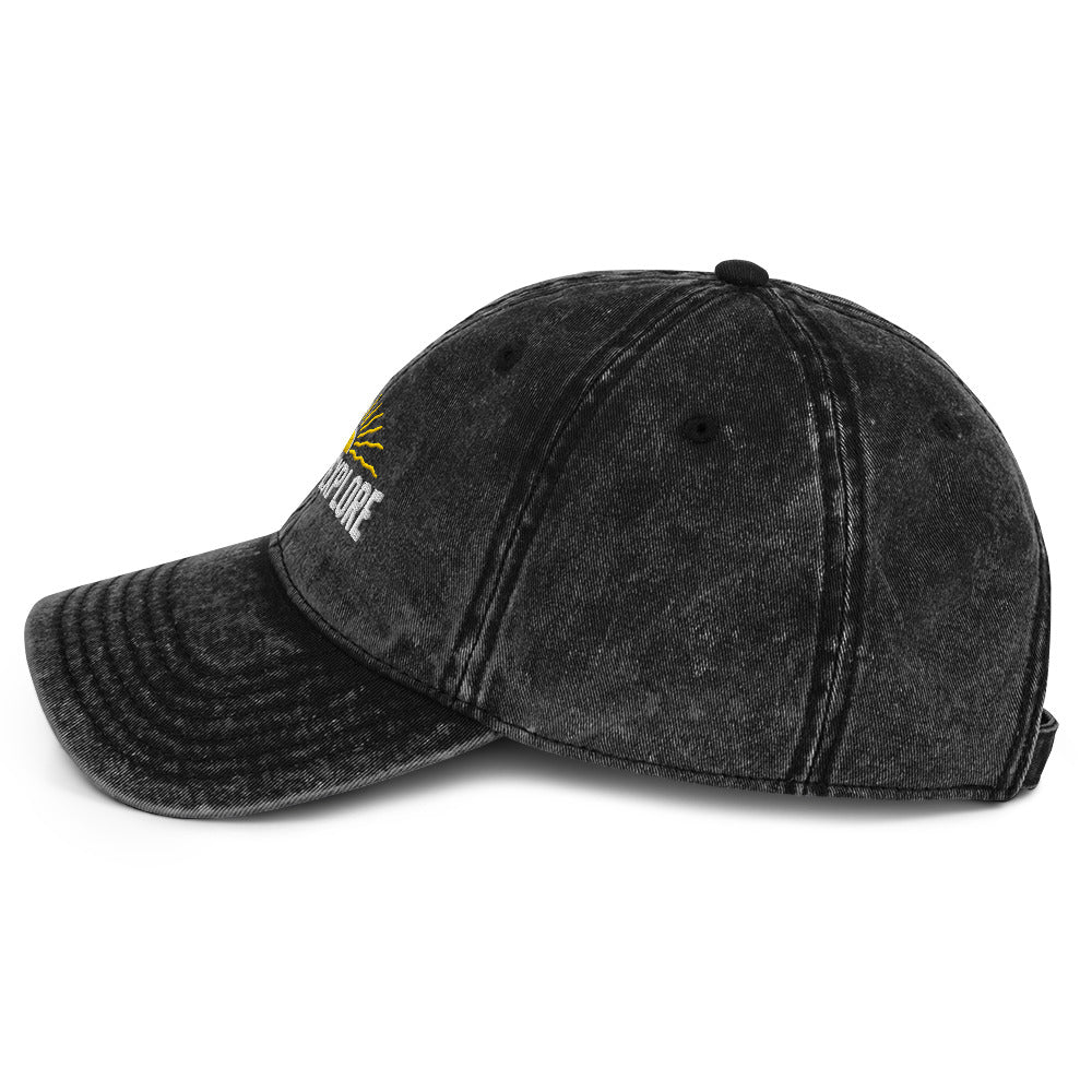 Black distressed baseball cap with born to explore logo on a white background