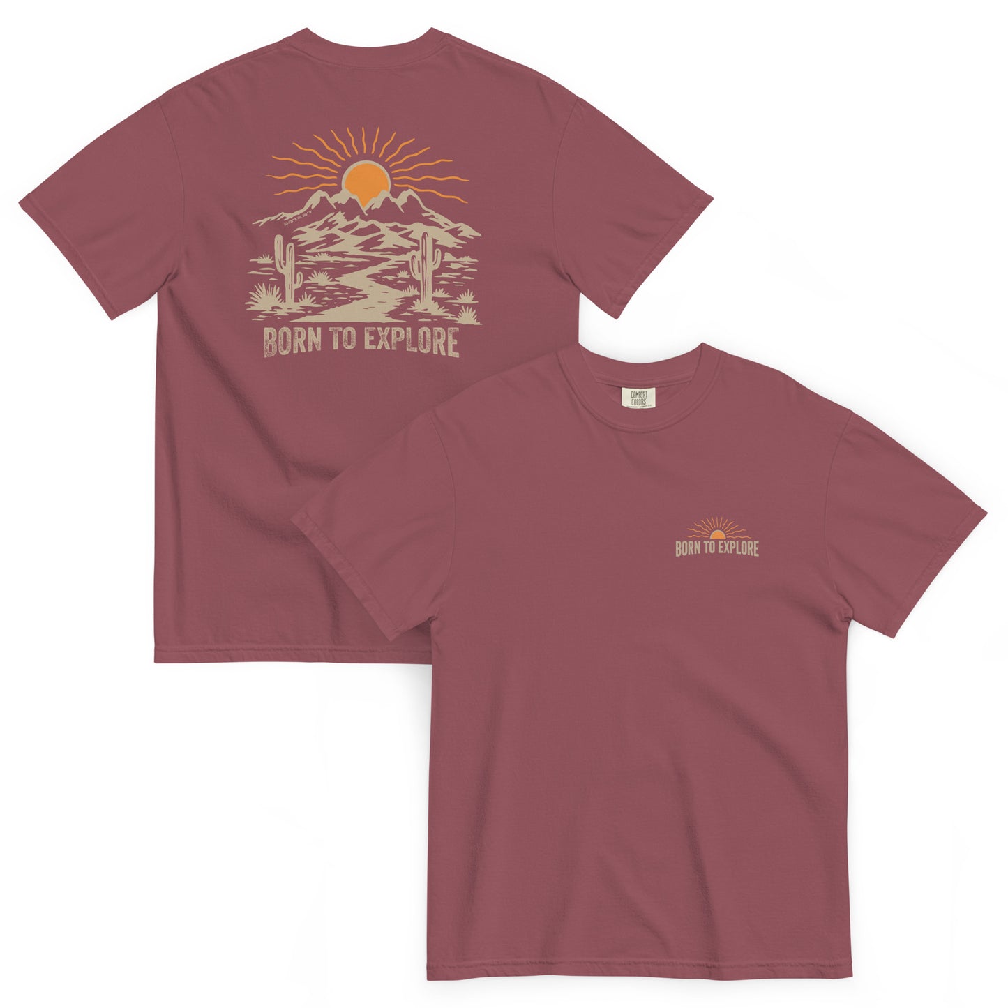 Maroon t-shirt with nature themed graphic design including mountains, sun, cacti and a dirt trail with 'Born to Explore' text on a white background