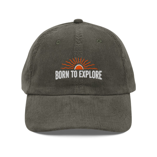 Gray/light green cap with 'Born to Explore' text and sun graphic on a white background