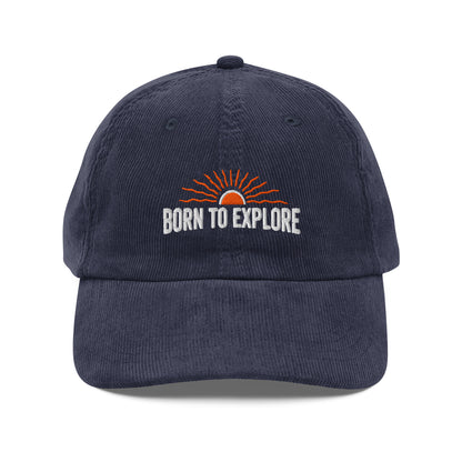 Navy blue cap with 'Born to Explore' text and sun graphic on a white background