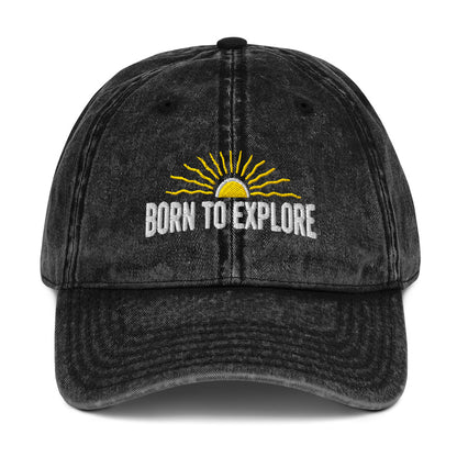 Black denim cap with 'Born to Explore' text and sun graphic on a white background