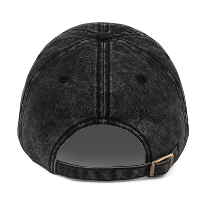 Black denim cap with a brown leather strap on a white background