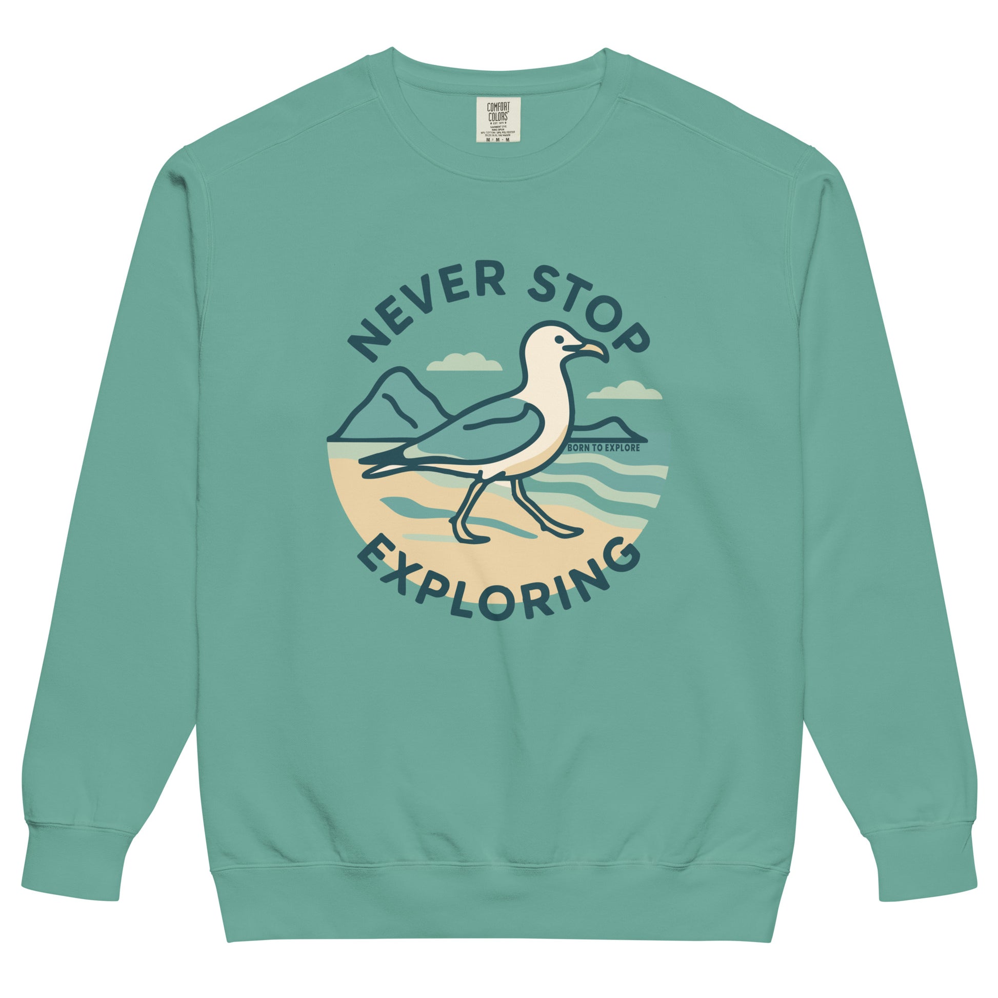 Teal sweatshirt with a seagull, beach and ocean graphic and 'Never Stop Exploring' text on a white background