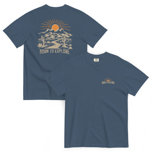 MIdnight blue t-shirt with nature themed graphic design including mountains, sun, cacti and a dirt trail with 'Born to Explore' text on a white background